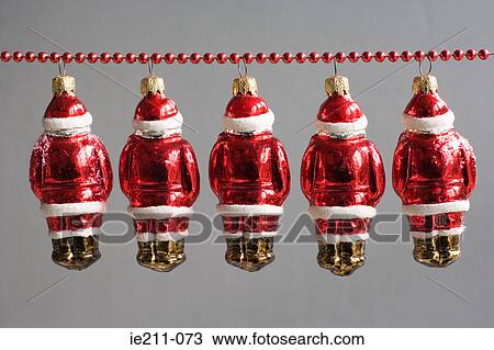 Santa claus decorations hanging in a row View Large Photo Image Stock Image - Santa claus decorations hanging in a row. Fotosearch