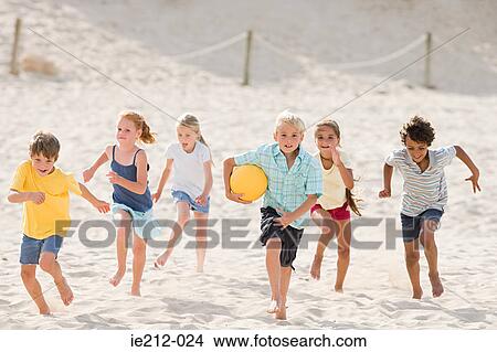 Children running across beach View Large Photo Image Picture - Children running across beach. Fotosearch