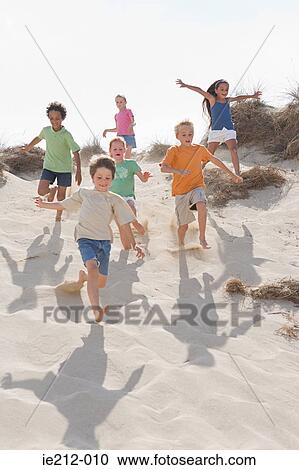 Children running down a dune View Large Photo Image Stock Image - Children running down a dune. Fotosearch