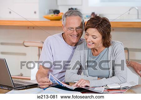A couple looking at brochures View Large Photo Image Stock Image - A couple looking at brochures. Fotosearch
