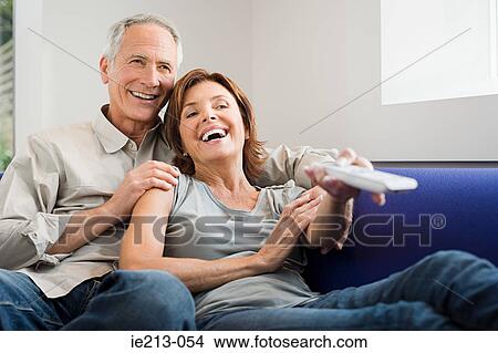 A couple watching tv View Large Photo Image Picture - A couple watching tv. Fotosearch