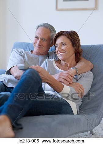 A couple watching tv View Large Photo Image Stock Photograph - A couple watching tv. Fotosearch