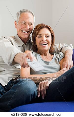 A couple watching tv View Large Photo Image Stock Photography - A couple watching tv. Fotosearch