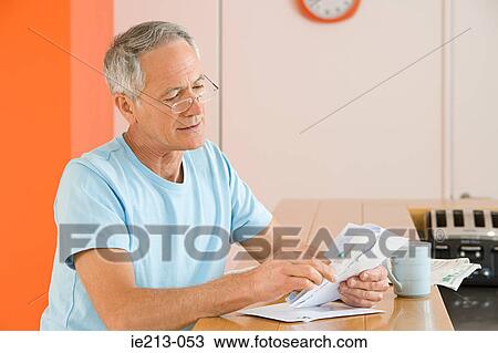 A man opening his mail View Large Photo Image Stock Image - A man opening his mail. Fotosearch
