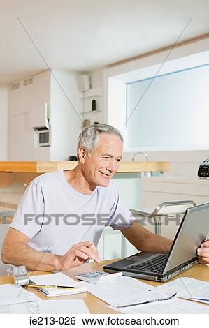 A man sorting out his home finances View Large Photo Image Stock Photograph - A man sorting out his home finances. Fotosearch
