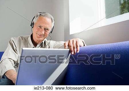 A man watching his laptop View Large Photo Image Stock Image - A man watching his laptop. Fotosearch