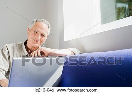 A man watching his laptop View Large Photo Image Stock Photography - A man watching his laptop. Fotosearch
