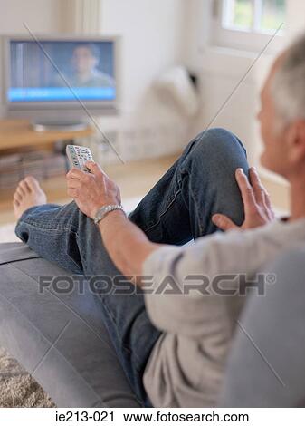 Stock Image - A man watching tv. Fotosearch