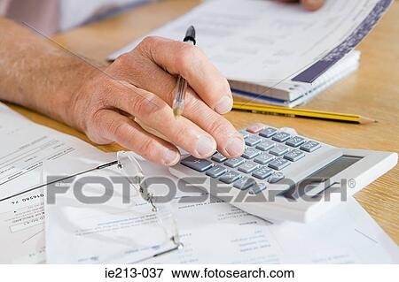 A person using a calculator View Large Photo Image Stock Photo - A person using a calculator. Fotosearch