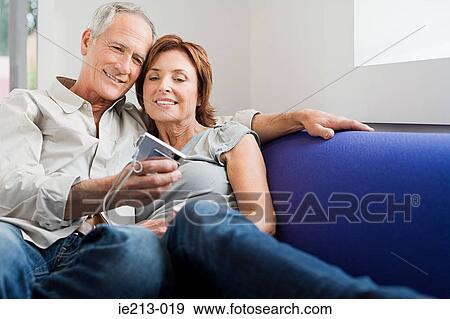 Stock Photo - A senior couple photographing themselves. Fotosearch