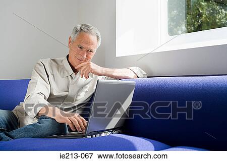 A senior man using a laptop View Large Photo Image Stock Photo - A senior man using a laptop. Fotosearch