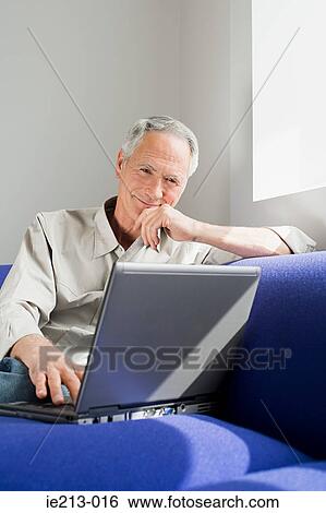 A senior man using a laptop View Large Photo Image Stock Photograph - A senior man using a laptop. Fotosearch