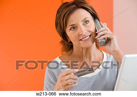 A woman telephone banking View Large Photo Image Stock Photograph - A woman telephone banking. Fotosearch
