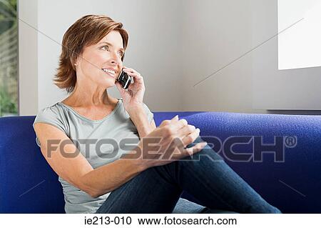 Stock Image - A woman using a cell phone. Fotosearch