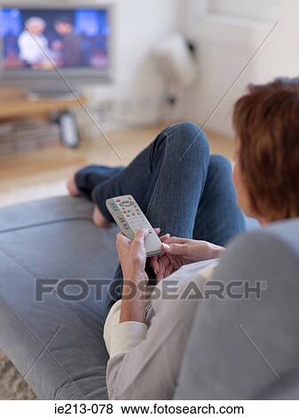 A woman watching tv View Large Photo Image Stock Photo - A woman watching tv. Fotosearch