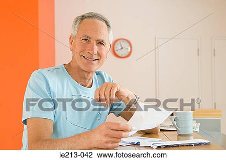 Stock Image - Portrait of a man holding a letter. Fotosearch