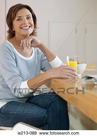 Portrait of a woman having breakfast View Large Photo Image Stock Photo - Portrait of a woman having breakfast. Fotosearch