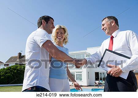 Couple and estate agent View Large Photo Image Stock Photo - Couple and estate agent. Fotosearch