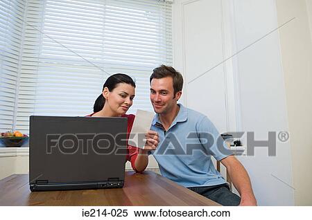 Stock Photography - Couple doing home finances. Fotosearch