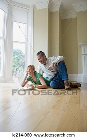 Stock Image - Couple using laptop. Fotosearch