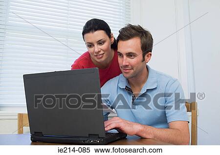 Couple using laptop View Large Photo Image Stock Photography - Couple using laptop. Fotosearch