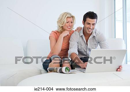 Couple with laptop View Large Photo Image Picture - Couple with laptop. Fotosearch