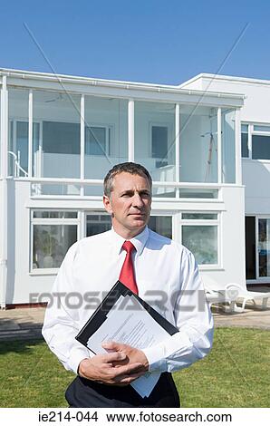 Picture - Estate agent and house. Fotosearch