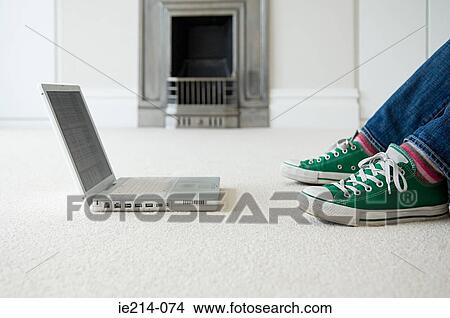 Feet of person and laptop View Large Photo Image Picture - Feet of person and laptop. Fotosearch