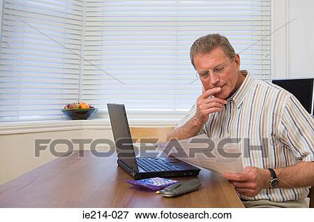 Man doing home finances View Large Photo Image Stock Photo - Man doing home finances. Fotosearch