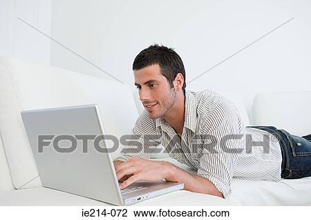 Stock Image - Man using laptop. Fotosearch