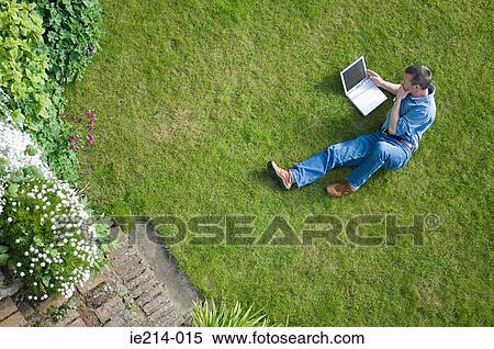 Man with laptop in garden View Large Photo Image Stock Photography - Man with laptop in garden. Fotosearch