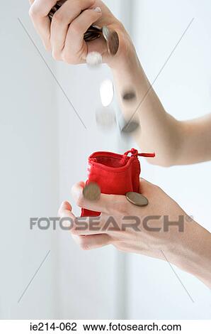 Person dropping coins into purse View Large Photo Image Stock Image - Person dropping coins into purse. Fotosearch