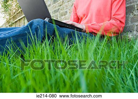 Person using laptop in garden View Large Photo Image Stock Image - Person using laptop in garden. Fotosearch