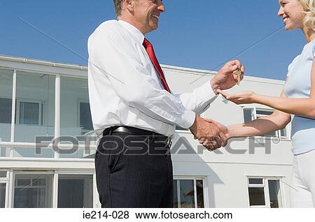 Woman and estate agent shaking hands View Large Photo Image Stock Photo - Woman and estate agent shaking hands. Fotosearch