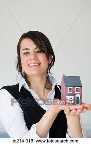 Woman holding a house View Large Photo Image Stock Photo - Woman holding a house. Fotosearch