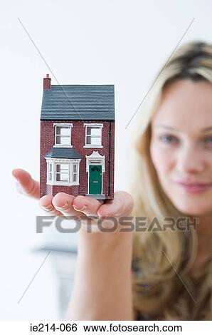 Woman holding a house View Large Photo Image Stock Photograph - Woman holding a house. Fotosearch