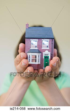 Woman holding a model house View Large Photo Image Stock Photo - Woman holding a model house. Fotosearch