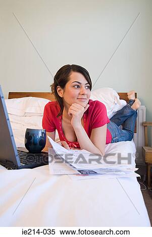 Woman on bed with bills View Large Photo Image Stock Photography - Woman on bed with bills. Fotosearch