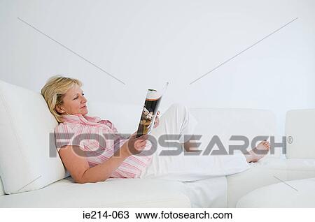Woman relaxing with magazine View Large Photo Image Stock Image - Woman relaxing with magazine. Fotosearch