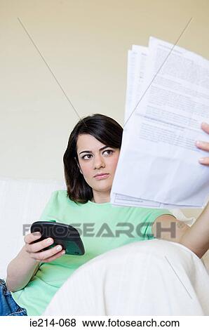 Woman with bills and calculator View Large Photo Image Stock Photo - Woman with bills and calculator. Fotosearch