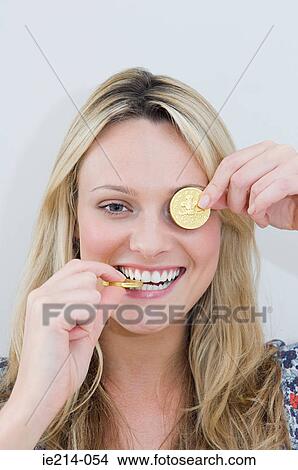 Woman with chocolate coins View Large Photo Image Picture - Woman with chocolate coins. Fotosearch