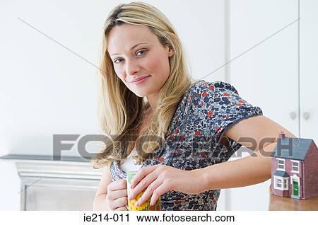 Woman with model of house View Large Photo Image Stock Image - Woman with model of house. Fotosearch