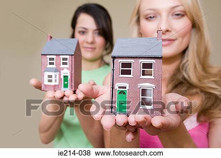 Women with model houses View Large Photo Image Stock Photo - Women with model houses. Fotosearch