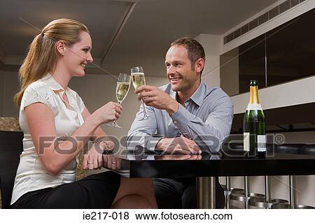 Couple drinking champagne in a bar View Large Photo Image Stock Photo - Couple drinking champagne in a bar. Fotosearch