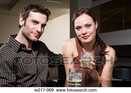 Couple drinking in a bar View Large Photo Image Stock Photo - Couple drinking in a bar. Fotosearch
