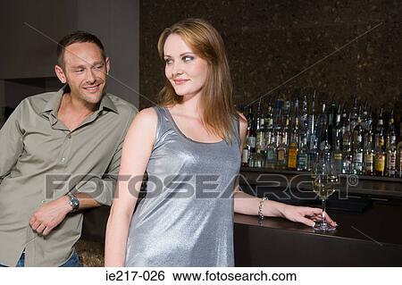 Couple flirting in a bar View Large Photo Image Stock Photograph - Couple flirting in a bar. Fotosearch