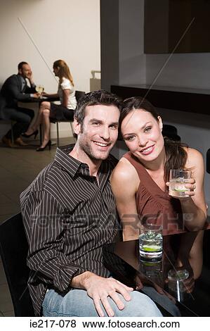 Stock Photo - Couples dating in a bar. Fotosearch