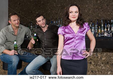 Men looking at a woman in bar View Large Photo Image Stock Photo - Men looking at a woman in bar. Fotosearch