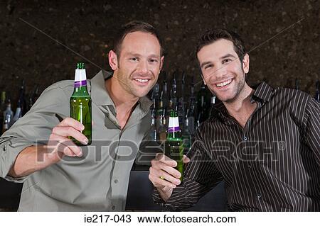 Two men drinking in a bar View Large Photo Image Stock Image - Two men drinking in a bar. Fotosearch