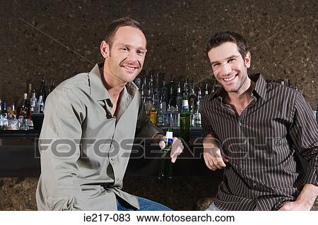 Two men drinking in a bar View Large Photo Image Stock Image - Two men drinking in a bar. Fotosearch